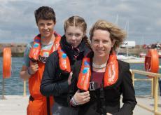 Pictured at the West Pier, Dun Laoghaire are Alan Roche (15) from Dundrum and Sorcha Duffy (13) from Deansgrange with Chief Executive of Bord Iascaigh Mhara (BIM) Tara McCarthy. BIM presented the Irish Youth Sailing Club with a set of 8 new compact lifejackets with integrated personal locator beacons.
